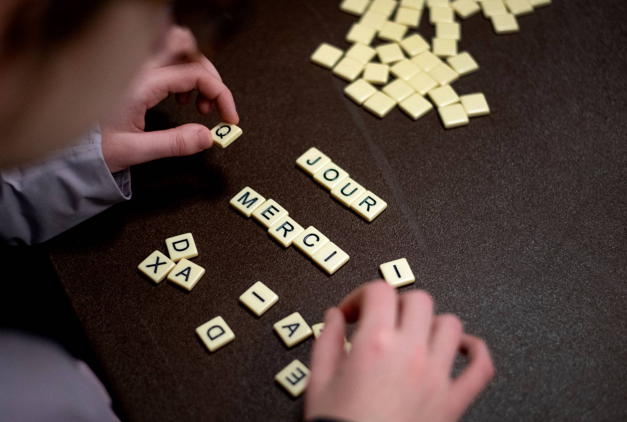 merci written in scrabble tiles